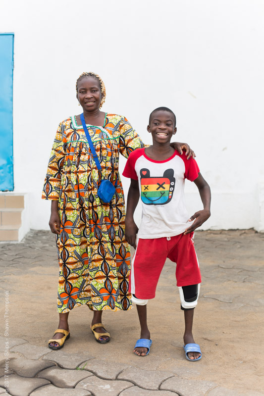 Ulrich, orthopedic patient, stands with straight legs next to his mother.